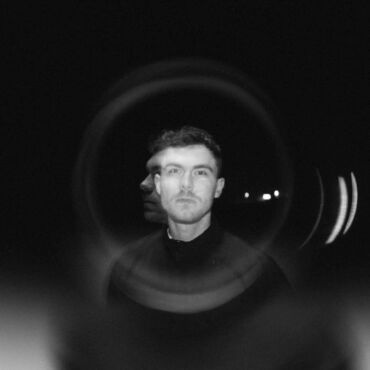 B&W double-exposure portrait through lens flare